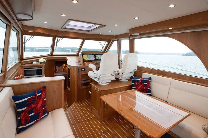 Slide: The Image of Luxurious interior of 2027 Sabre 45 Salon Express yacht with elegant seating and navigation area. - 8