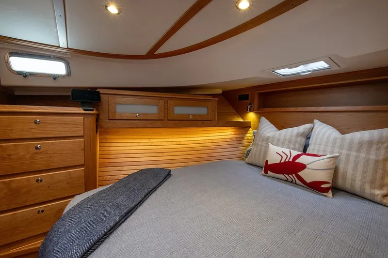 Slide: The Image of Luxurious cabin interior of 2027 Sabre 45 Salon Express with cozy bedding and wooden accents. - 5