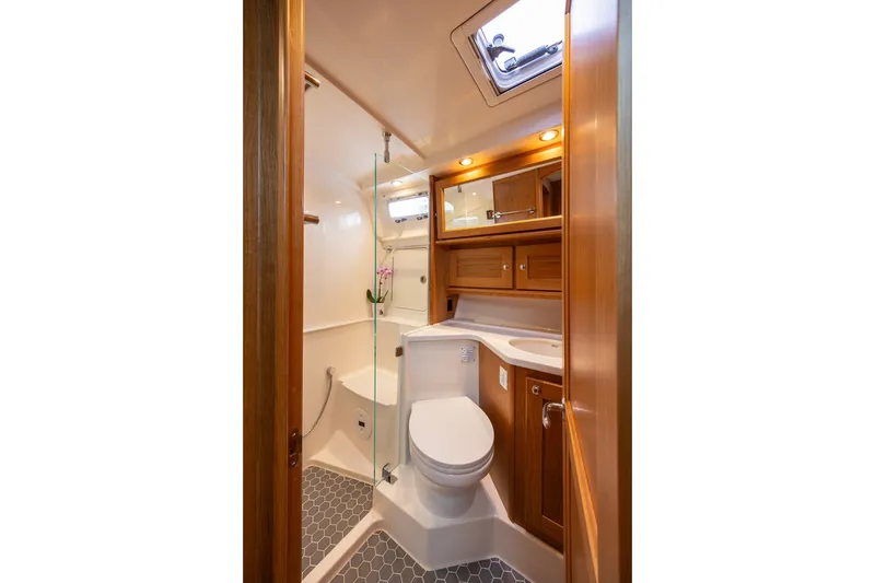 Slide: The Image of Luxurious bathroom interior of 2027 Sabre 45 Salon Express yacht, featuring wood cabinetry and modern fixtures. - 13