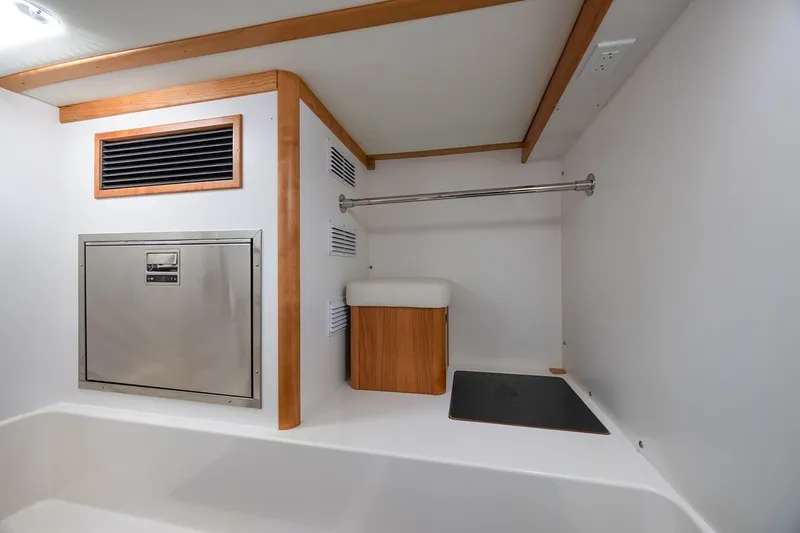 Slide: The Image of Laundry area in 2027 Sabre 45 Salon Express yacht with modern design and wood accents. - 15