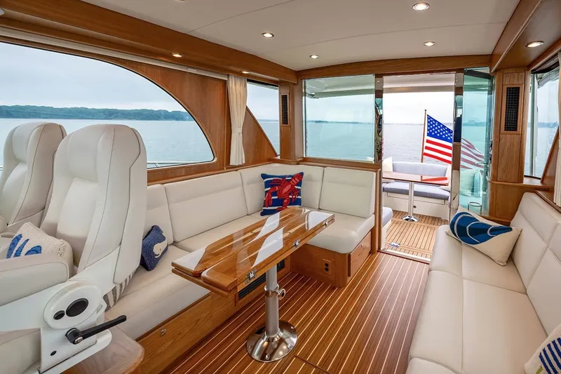 Slide: The Image of Interior of 2027 Sabre 45 Salon Express yacht with elegant seating and wooden finishes. - 3