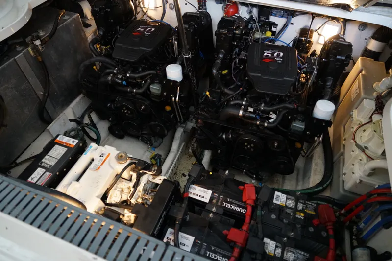 Slide: The Image of Engine compartment of a 2006 Sea Ray 300 Sundancer with dual engines and batteries. - 35