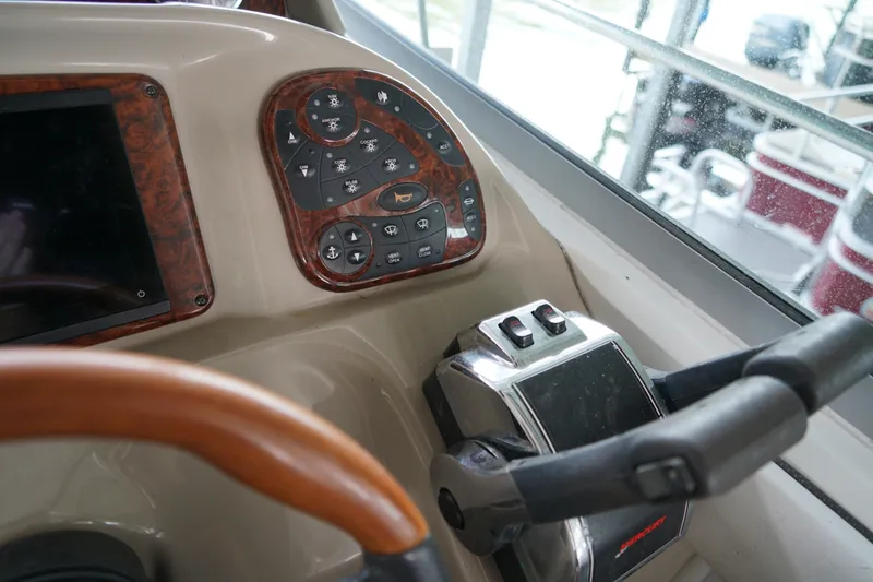 Slide: The Image of Control panel of a 2006 Sea Ray 300 Sundancer boat with steering wheel. - 20