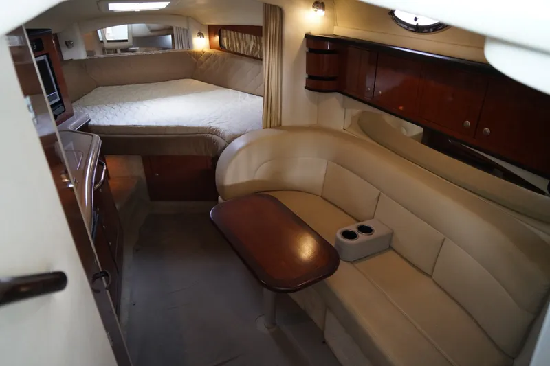 Slide: The Image of Interior of the 2006 Sea Ray 300 Sundancer with cozy seating area and sleeping space. - 25