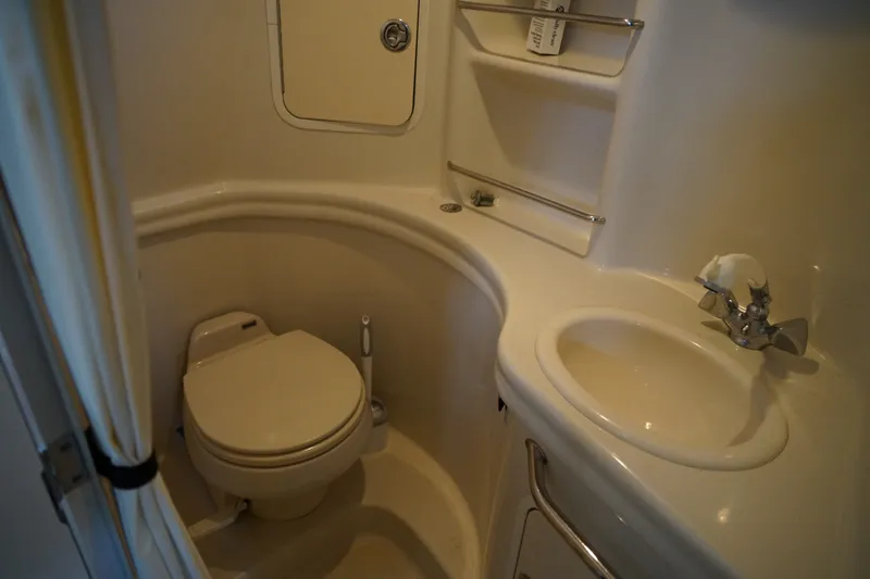 Slide: The Image of Compact bathroom in 2006 Sea Ray 300 Sundancer yacht with toilet and sink. - 33
