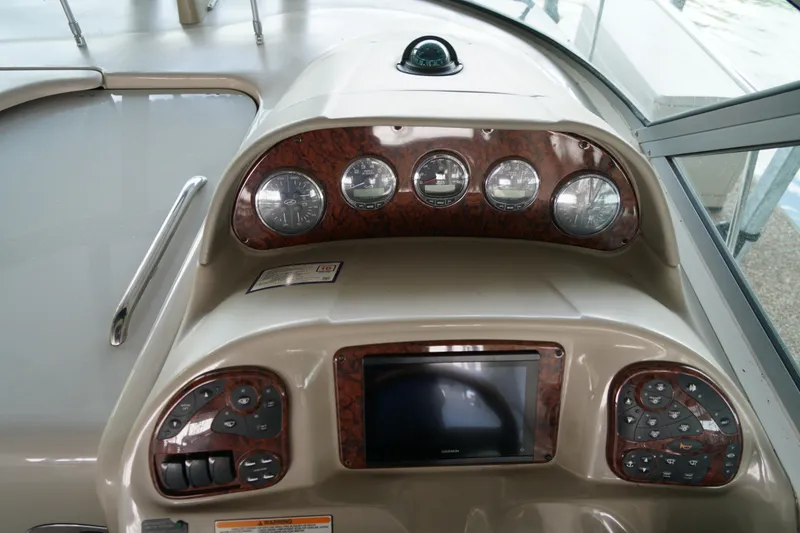 Slide: The Image of Dashboard of a 2006 Sea Ray 300 Sundancer boat with gauges and controls. - 23