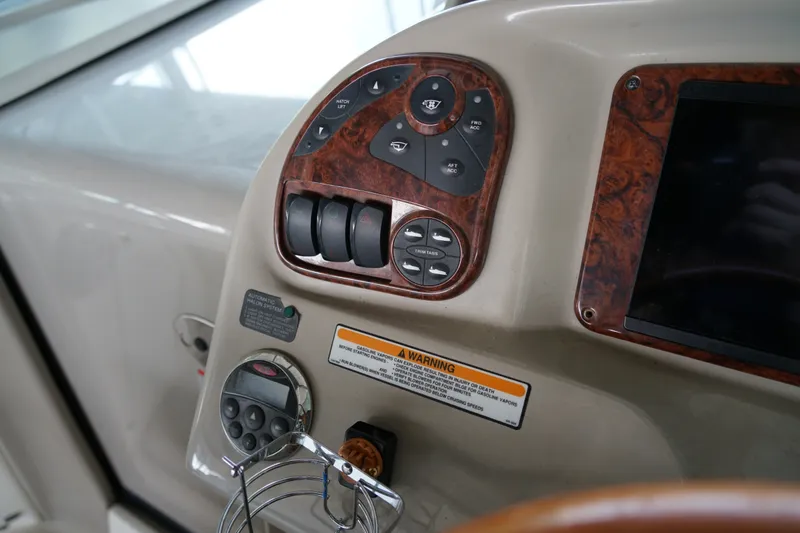 Slide: The Image of Control panel of a 2006 Sea Ray 300 Sundancer boat with wood trim accents. - 21