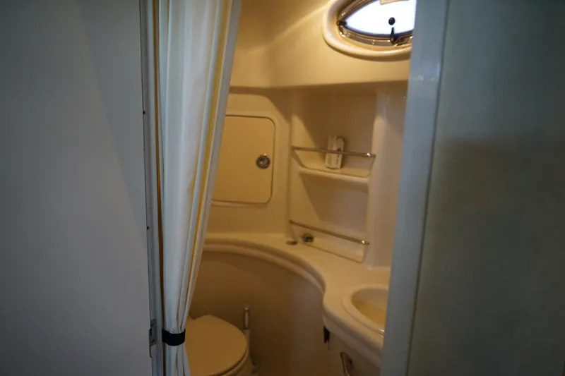 Slide: The Image of Bathroom interior of 2006 Sea Ray 300 Sundancer yacht, featuring compact design and amenities. - 32