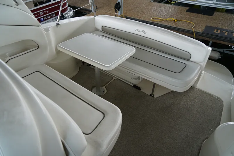 Slide: The Image of Interior seating area of a 2006 Sea Ray 300 Sundancer boat with table. - 17