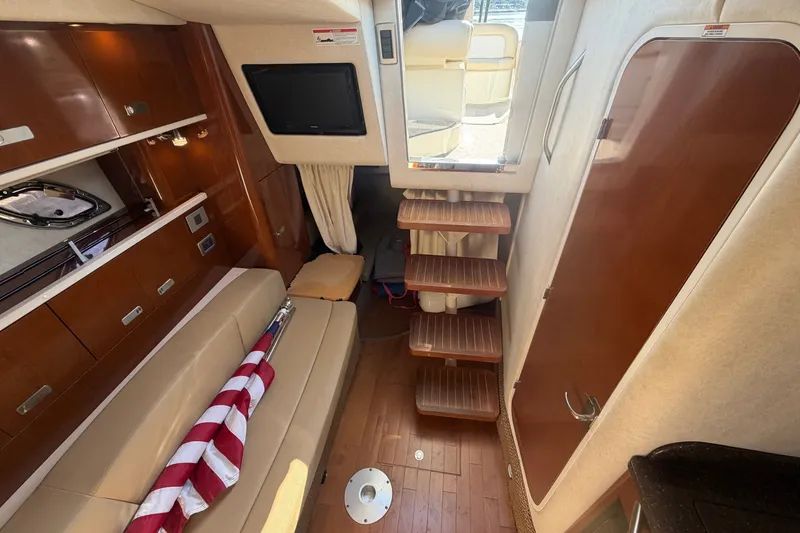 Slide: The Image of Interior of 2012 Sea Ray Sundancer 330 with wooden steps and seating area. - 14