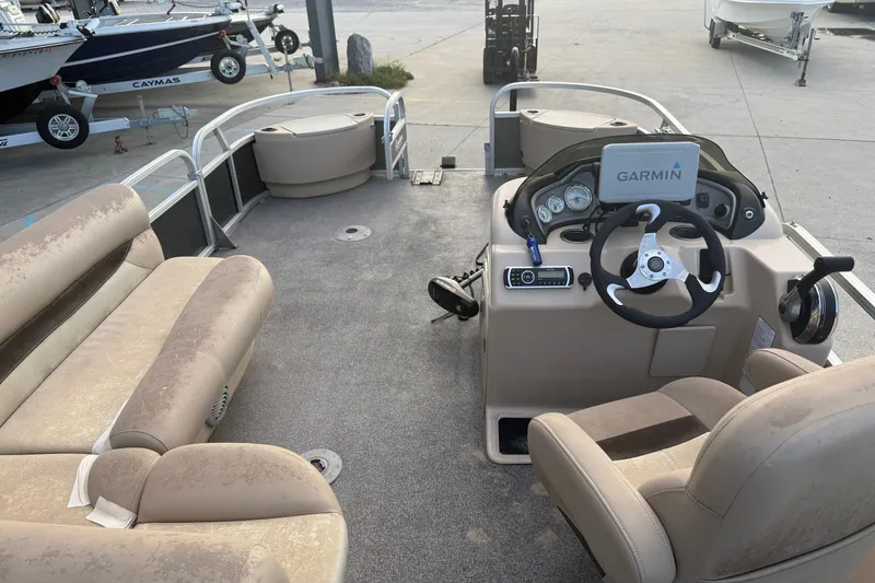 Slide: The Image of 2015 Sun Tracker Fishin' Barge 22 DLX interior with Garmin navigation system and seating. - 14