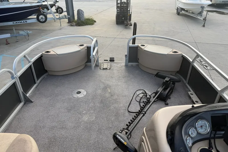 Slide: The Image of 2015 Sun Tracker Fishin' Barge 22 DLX interior with seating and trolling motor. - 16