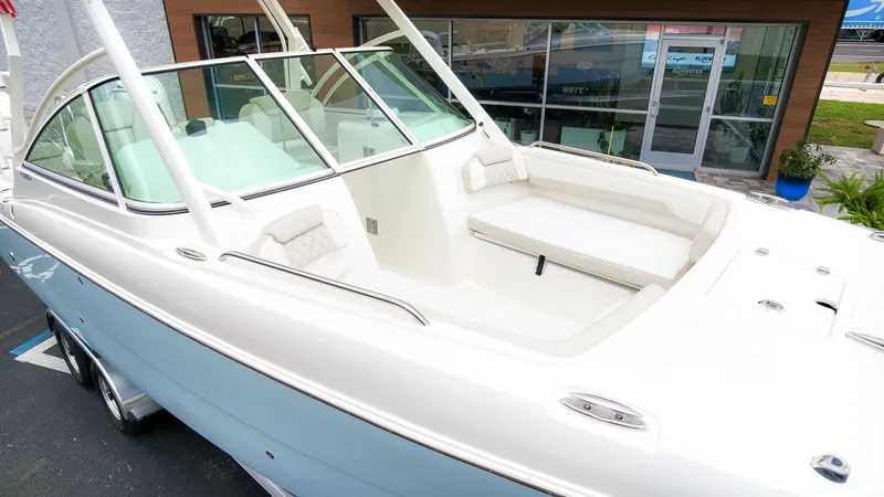 The Image of The image shows a 2027 World Cat 230 DC boat with a spacious, cushioned seating area. - 1
