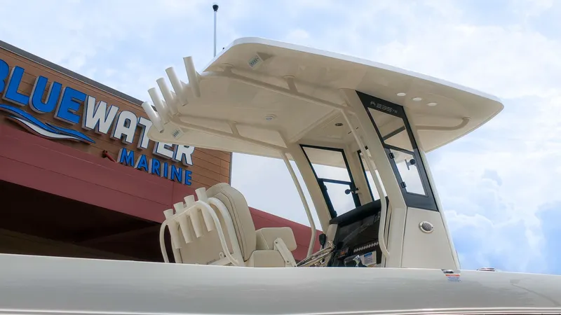 The Image of A modern boat with a sleek white roof and comfortable seating, in front of a marine building. - 1