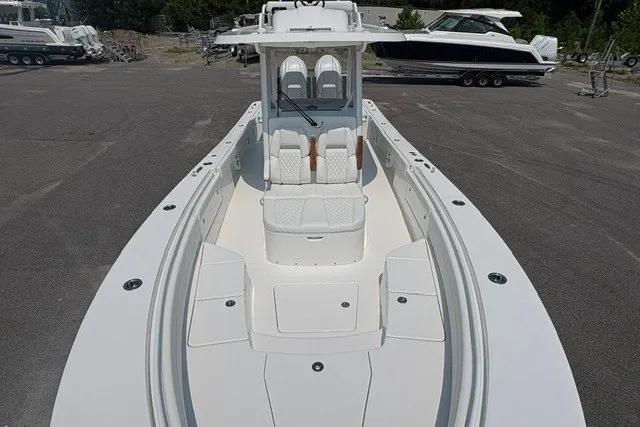 Slide: The Image of 2027 Regulator 30XO boat with spacious deck and seating, parked outdoors. - 26