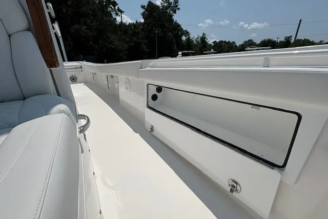 Slide: The Image of 2027 Regulator 30XO boat interior with open storage compartment, showcasing sleek white design. - 15