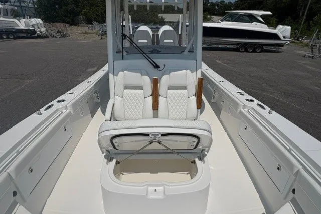 Slide: The Image of 2027 Regulator 30XO boat interior with white seating and storage compartment. - 28