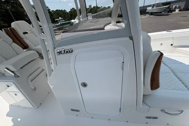 Slide: The Image of 2027 Regulator 30XO boat interior with white seating and storage compartment. - 17