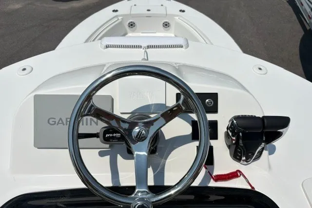 Slide: The Image of 2027 Regulator 30XO boat helm with Garmin navigation and steering wheel. - 22