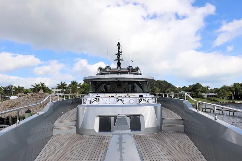 Slide: The Image of Majesty 120 yacht, 2025 model, sleek design, docked under blue sky. - 21