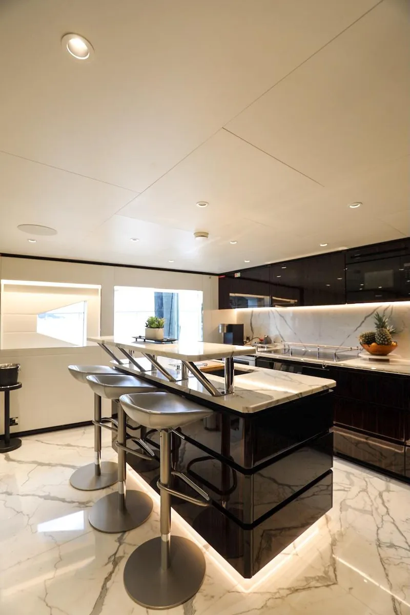 Slide: The Image of Luxurious 2025 Majesty 120 yacht interior with modern kitchen and sleek marble flooring. - 42