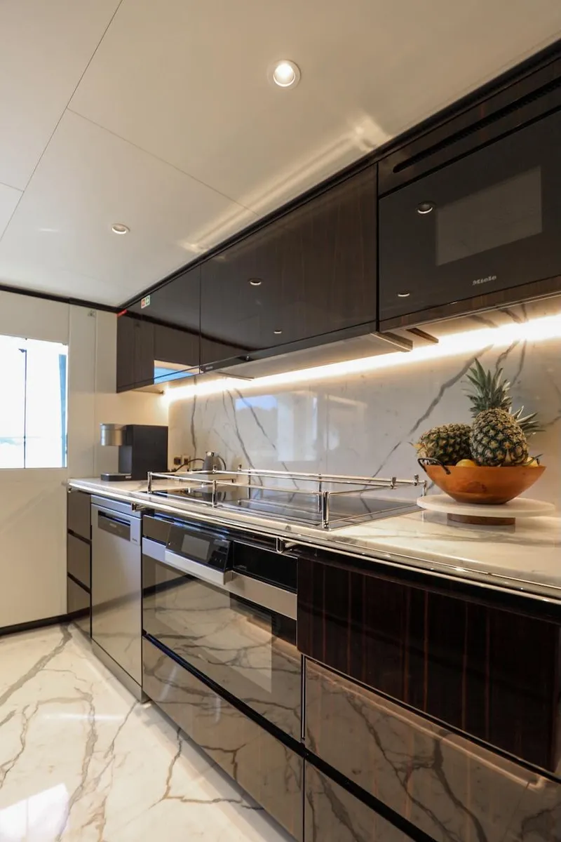 Slide: The Image of Luxurious kitchen in 2025 Majesty 120 yacht with sleek cabinets and marble flooring. - 40
