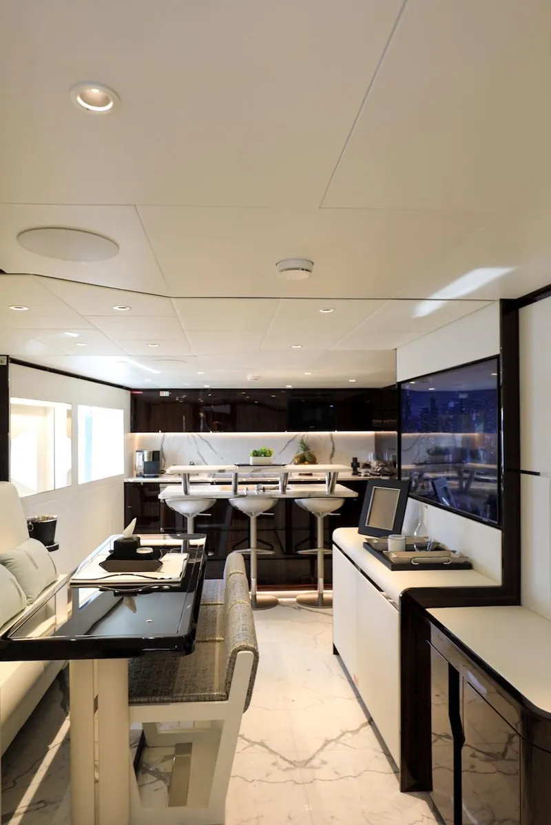 Slide: The Image of Luxurious interior of 2025 Majesty 120 yacht with modern dining and lounge area. - 34