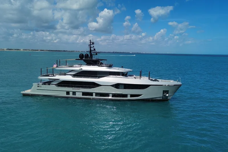 Slide: The Image of Luxurious 2025 Majesty 120 yacht cruising on clear blue ocean under a bright sky. - 2