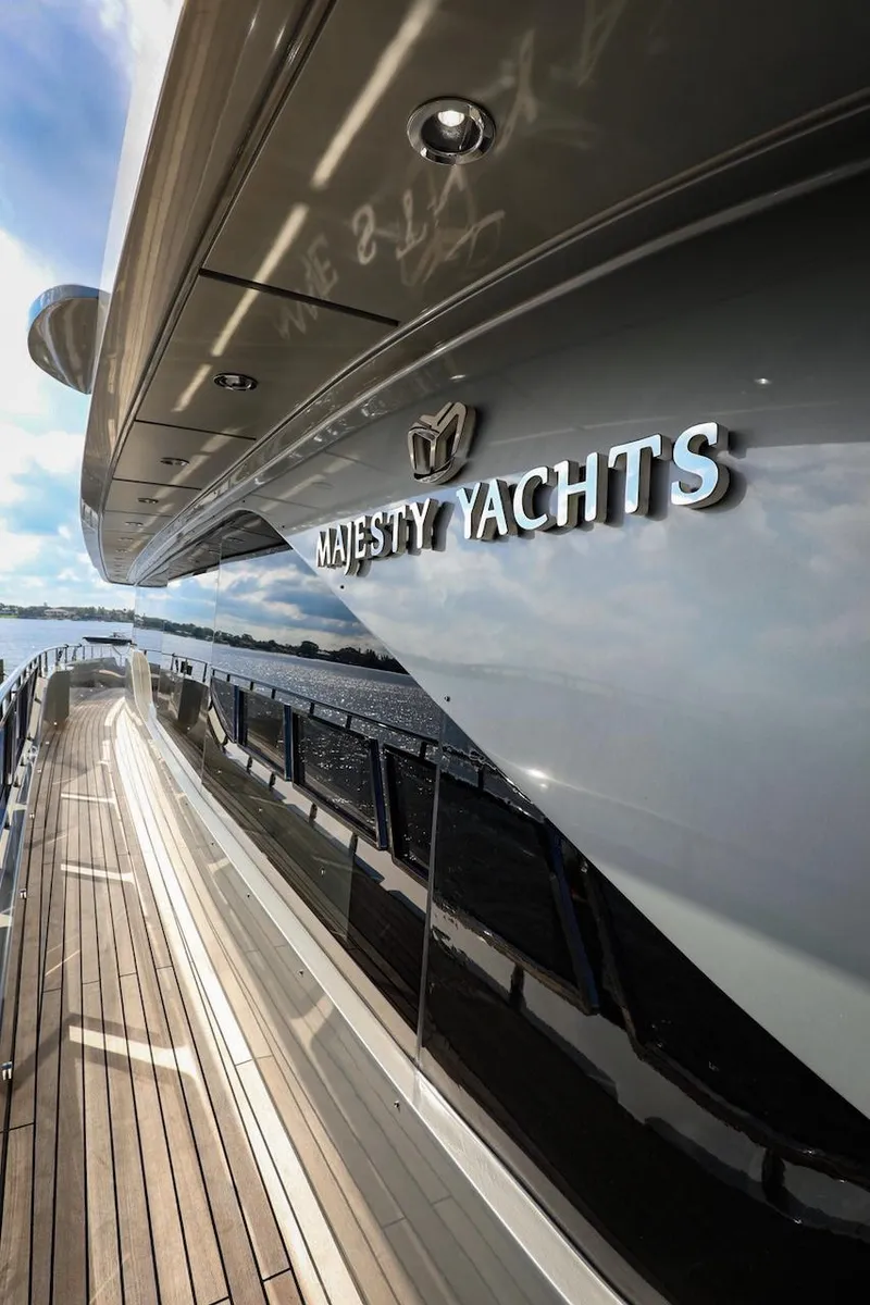 Slide: The Image of Majesty 120 yacht, 2025 model, sleek design with wooden deck and reflective hull. - 16