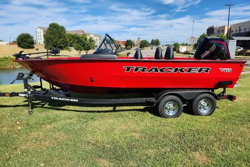 The Image of 2026 Tracker Targa V-19 WT boat on trailer, vibrant red, parked on grass. - 0
