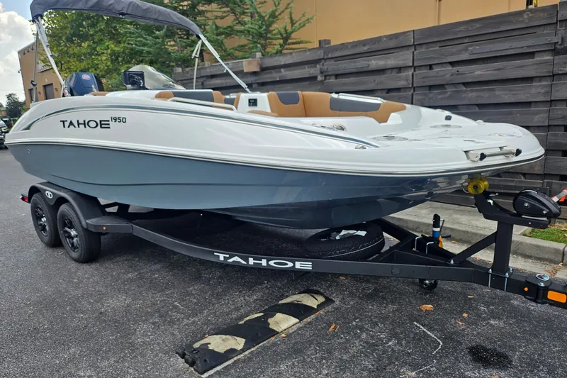 Slide: The Image of 2026 Tahoe 1950 boat on trailer, parked outdoors. - 3