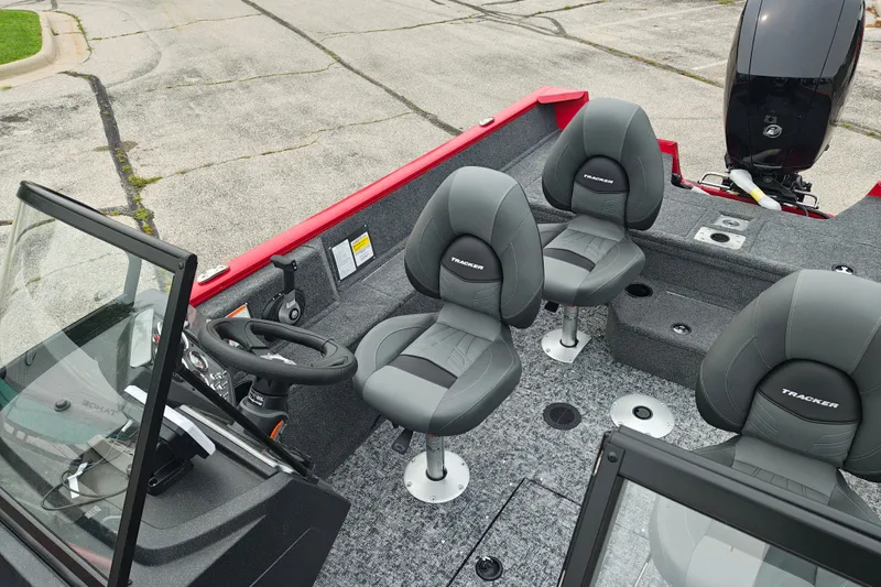 Slide: The Image of 2026 Tracker Pro Guide V-175 WT boat interior with gray seating and steering console. - 22