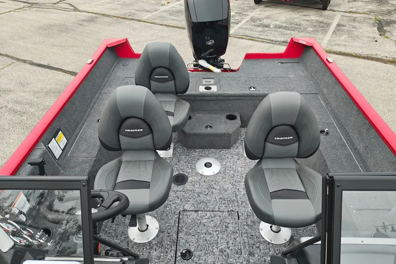 Slide: The Image of 2026 Tracker Pro Guide V-175 WT boat interior with three gray seats and red trim. - 20