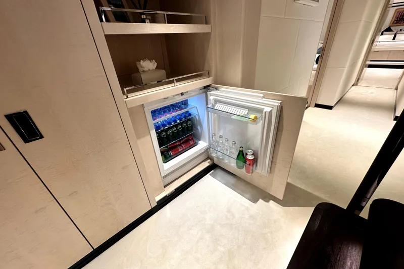 Slide: The Image of Mini fridge in 2023 Majesty 120 yacht, stocked with beverages, open in luxurious interior. - 39