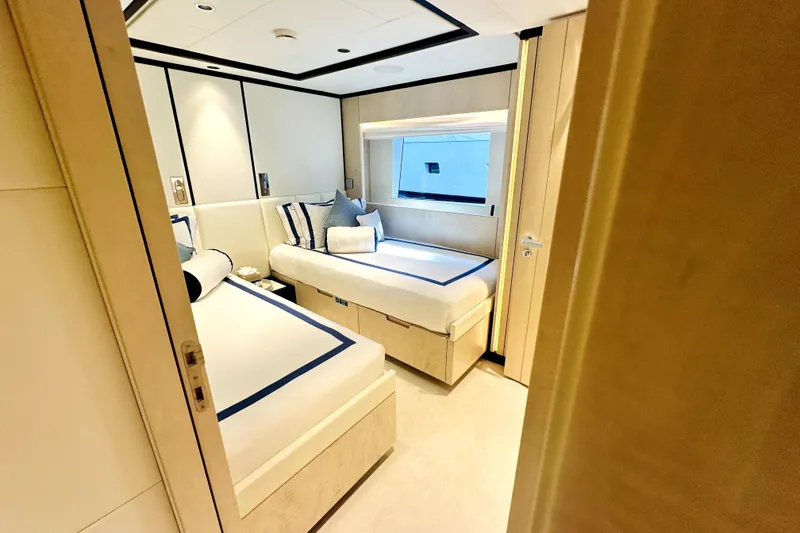 Slide: The Image of Luxurious cabin interior of 2023 Majesty 120 yacht with twin beds and modern decor. - 16