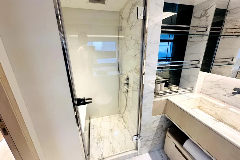 Slide: The Image of Luxurious marble bathroom in 2023 Majesty 120 yacht, featuring glass shower and modern fixtures. - 18