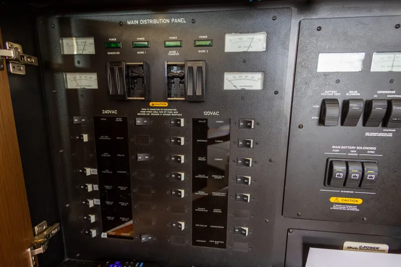 Slide: The Image of Main distribution panel on 2017 Sea Ray Fly 510 yacht, featuring switches and gauges. - 53