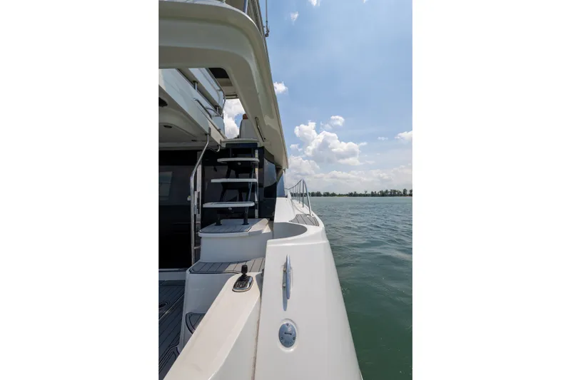 Slide: The Image of 2017 Sea Ray Fly 510 yacht side view with stairs, on a sunny day at sea. - 7