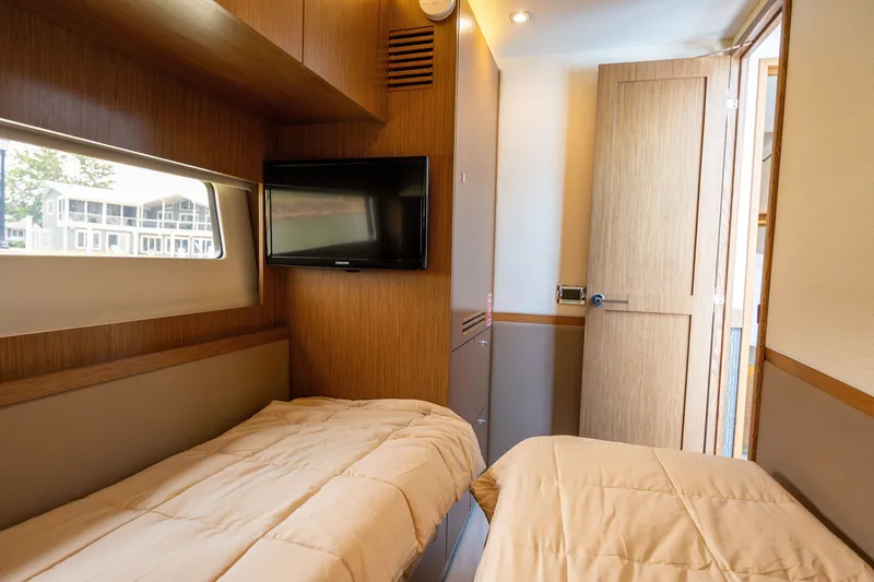 Slide: The Image of Interior cabin of 2017 Sea Ray Fly 510 yacht with twin beds and TV. - 39