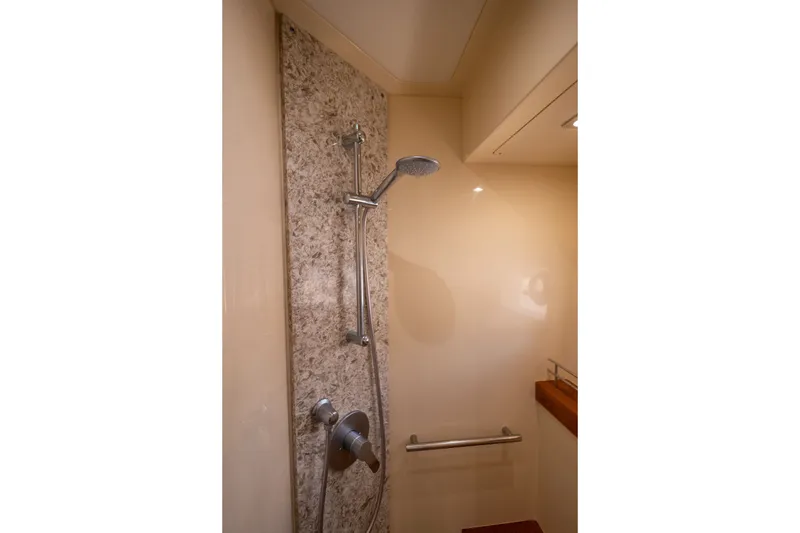 Slide: The Image of Shower area in 2017 Sea Ray Fly 510 yacht with modern fixtures and granite wall. - 47