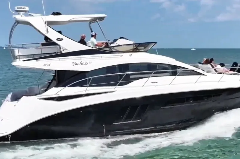 Slide: The Image of 2017 Sea Ray Fly 510 yacht cruising on the ocean with passengers onboard. - 58