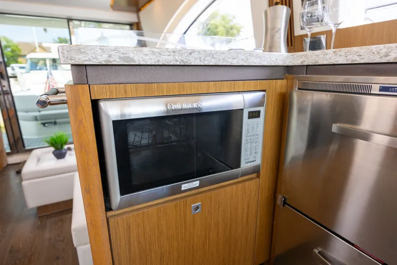 Slide: The Image of Modern kitchen interior on 2017 Sea Ray Fly 510 yacht with microwave and stainless appliances. - 36