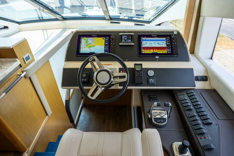 Slide: The Image of Cockpit of 2017 Sea Ray Fly 510 yacht with advanced navigation systems and controls. - 32