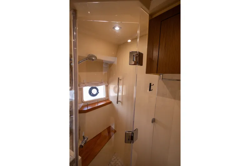 Slide: The Image of Luxurious shower area in 2017 Sea Ray Fly 510 yacht with glass door and wooden accents. - 50