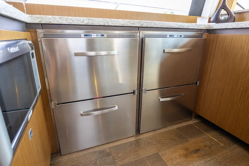 Slide: The Image of Stainless steel kitchen appliances on 2017 Sea Ray Fly 510 yacht, featuring modern cabinetry. - 35