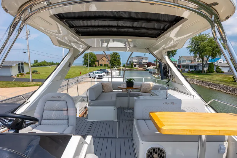 Slide: The Image of Luxurious 2017 Sea Ray Fly 510 yacht interior with elegant seating and scenic waterfront view. - 18