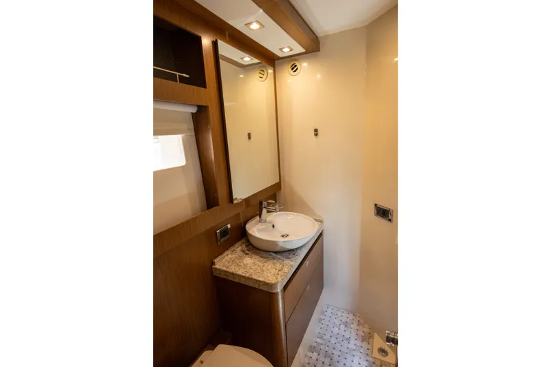 Slide: The Image of Luxurious bathroom in 2017 Sea Ray Fly 510 yacht with modern fixtures and wood accents. - 48