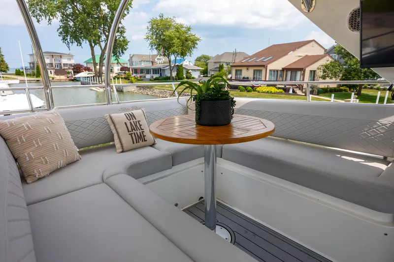 Slide: The Image of Luxurious 2017 Sea Ray Fly 510 yacht interior with cozy seating and lake view. - 12