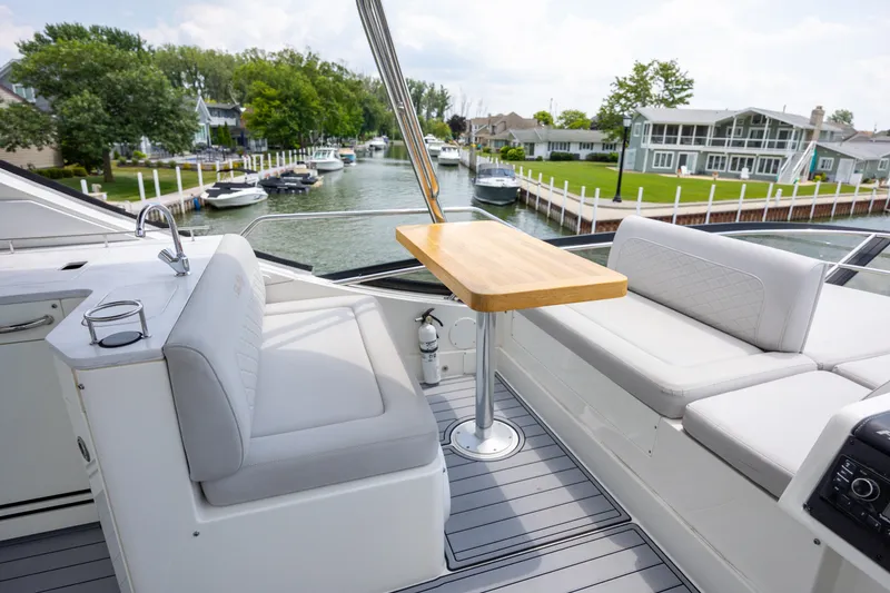 Slide: The Image of Luxurious seating area on a 2017 Sea Ray Fly 510 yacht, docked by a scenic canal. - 14