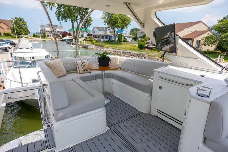 Slide: The Image of Luxurious 2017 Sea Ray Fly 510 yacht with elegant seating and scenic waterfront view. - 11